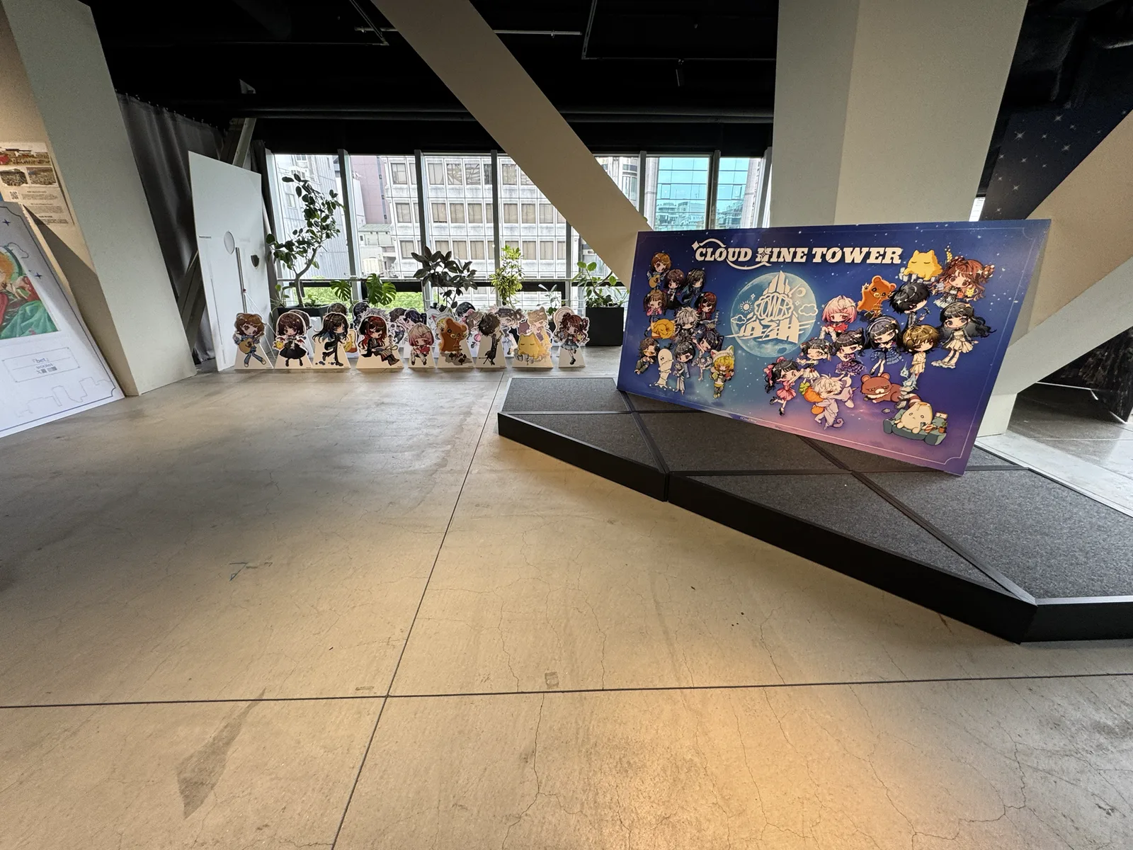 CLOUD NINE TOWERのキービジュアルとキャラクタースタンディが並ぶ名古屋会場の展示エリア